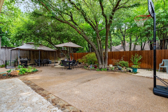 4705 El Salvador Ct, Arlington, TX 76017 - view of patio featuring a fenced backyard, outdoor dining space, a gazebo, and grilling area