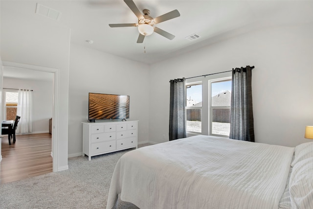 bedroom featuring carpet floors, baseboards, visible vents, and ceiling fan