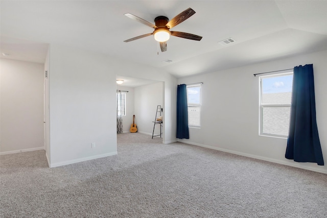 spare room featuring a ceiling fan, baseboards, visible vents, and carpet