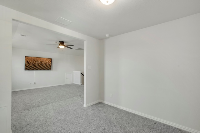 unfurnished room featuring a ceiling fan, baseboards, visible vents, and carpet