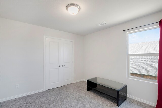 unfurnished bedroom with visible vents, carpet flooring, and baseboards