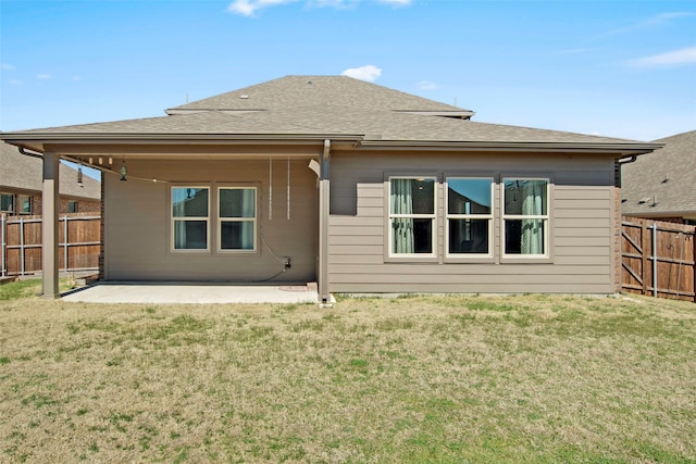 rear view of property with a patio, a fenced backyard, and a lawn