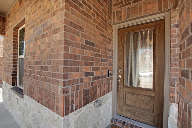 entrance to property with brick siding