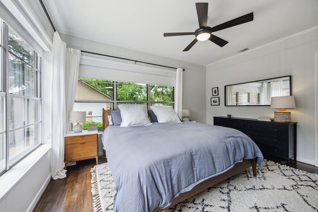 bedroom featuring baseboards, ceiling fan, ornamental molding, and wood finished floors
