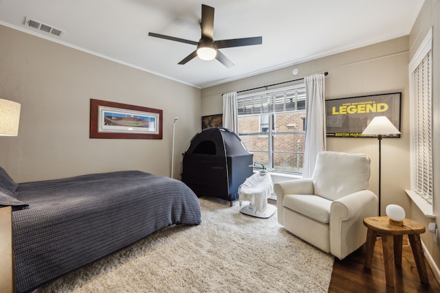 bedroom with ornamental molding, a ceiling fan, and visible vents