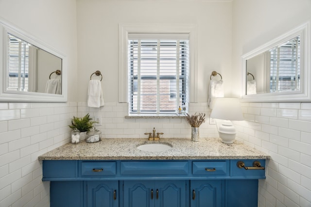 bathroom featuring tile walls, plenty of natural light, and vanity