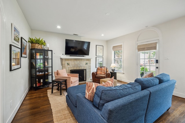 living room with baseboards, recessed lighting, dark wood-style floors, and a fireplace