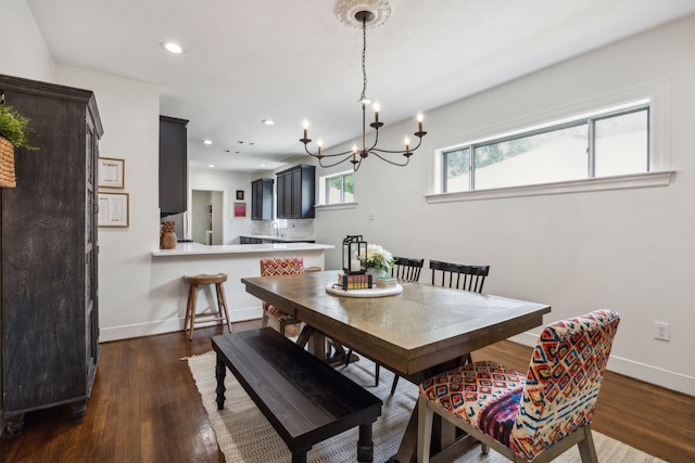 dining area featuring baseboards, dark wood-type flooring, recessed lighting, and a chandelier