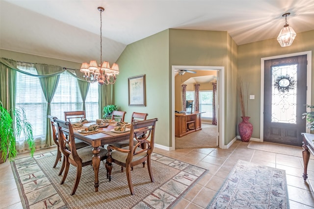 dining space with light tile patterned floors, baseboards, a chandelier, and lofted ceiling