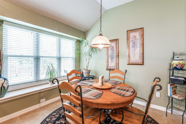 dining area with baseboards, light tile patterned flooring, and lofted ceiling