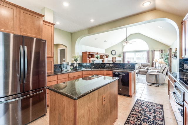kitchen with arched walkways, freestanding refrigerator, a peninsula, lofted ceiling, and black dishwasher
