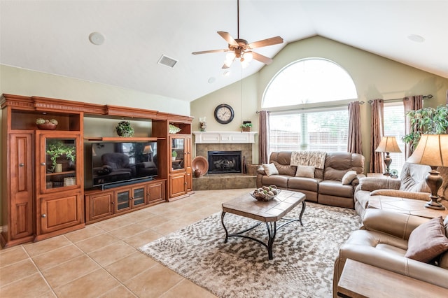 living room with visible vents, high vaulted ceiling, a tiled fireplace, a ceiling fan, and light tile patterned floors