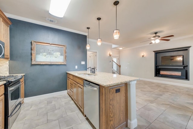 kitchen featuring a sink, appliances with stainless steel finishes, crown molding, and light stone countertops