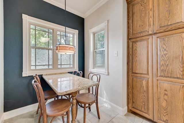 dining area featuring baseboards, plenty of natural light, crown molding, and light tile patterned flooring