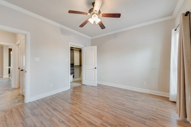 unfurnished bedroom featuring a closet, ornamental molding, baseboards, light wood-type flooring, and a ceiling fan