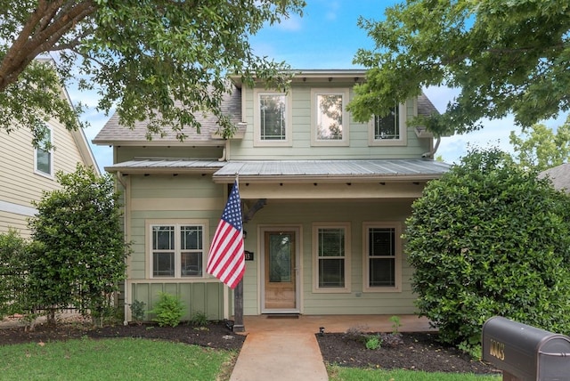 view of front of home with a porch and metal roof