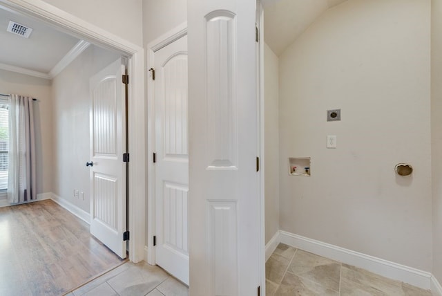 hallway with baseboards, visible vents, ornamental molding, and vaulted ceiling