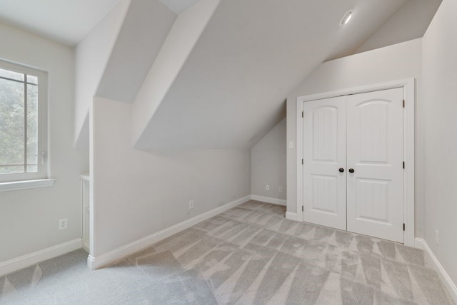 bonus room with baseboards, carpet flooring, and lofted ceiling