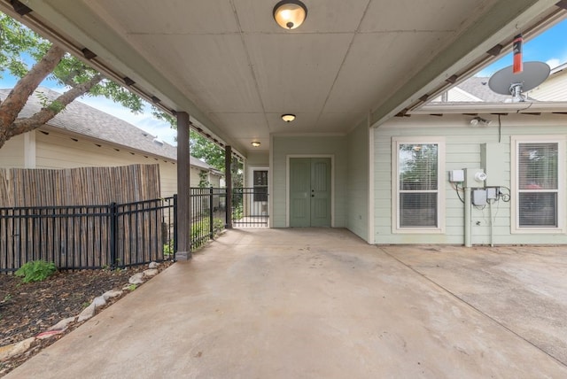 view of patio with fence and an attached carport