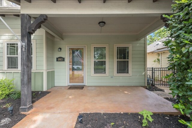 view of exterior entry with fence