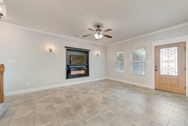 interior space with visible vents, ornamental molding, baseboards, and ceiling fan