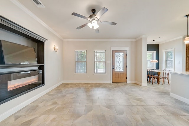 entrance foyer featuring crown molding, baseboards, a ceiling fan, and visible vents
