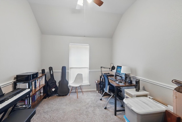 carpeted office space with ceiling fan and vaulted ceiling