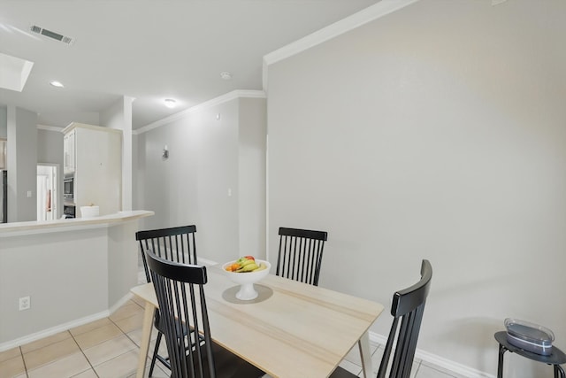 dining room with visible vents, baseboards, crown molding, and light tile patterned floors