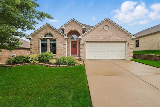 single story home featuring an attached garage, driveway, a front lawn, and brick siding