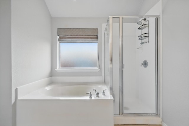 bathroom with a garden tub and a stall shower