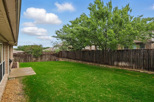 view of yard with a fenced backyard