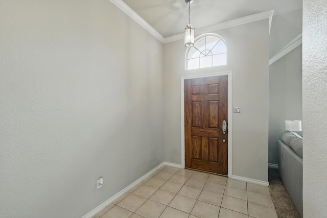 foyer entrance with crown molding, baseboards, and light tile patterned floors