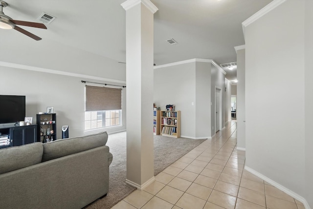 living area with light tile patterned floors, ceiling fan, ornamental molding, and visible vents