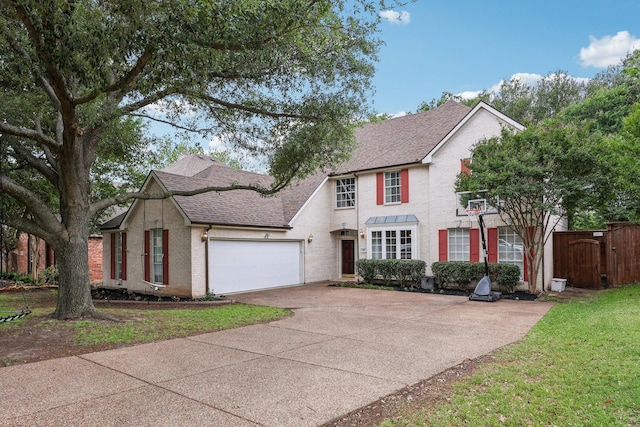 view of front of home with roof with shingles, fence, concrete driveway, and a garage