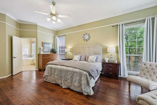 bedroom featuring crown molding, ceiling fan, dark wood finished floors, and ensuite bath