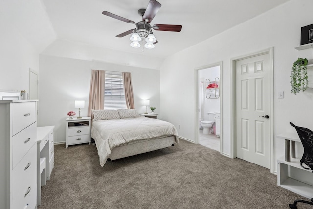bedroom with baseboards, ceiling fan, dark carpet, and connected bathroom