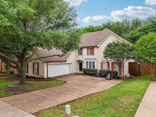view of front facade featuring fence, a front yard, stucco siding, a shingled roof, and concrete driveway