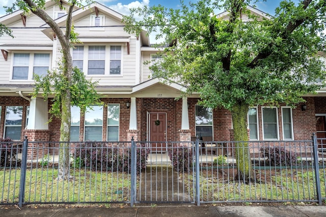 172 High School Dr, Lewisville, TX 75057 - view of property with a fenced front yard, a porch, and brick siding