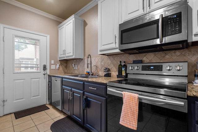 172 High School Dr, Lewisville, TX 75057 - kitchen with crown molding, white cabinets, a sink, appliances with stainless steel finishes, and light tile patterned floors