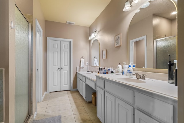 172 High School Dr, Lewisville, TX 75057 - full bath with visible vents, double vanity, tile patterned floors, a shower stall, and a sink