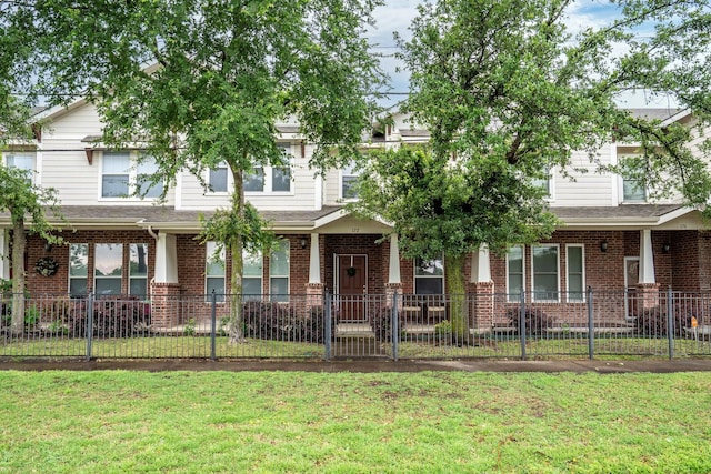 172 High School Dr, Lewisville, TX 75057 - view of front facade with brick siding, fence private yard, and a front lawn