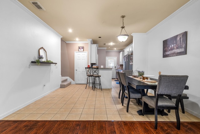 172 High School Dr, Lewisville, TX 75057 - dining space with visible vents, ornamental molding, baseboards, recessed lighting, and light tile patterned floors