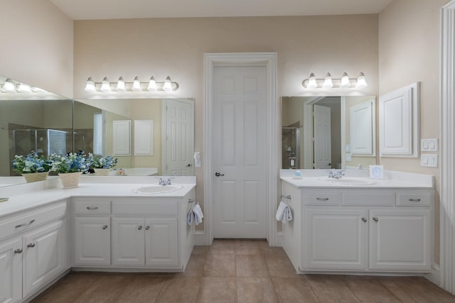 full bathroom with two vanities, a shower stall, a sink, and tile patterned flooring