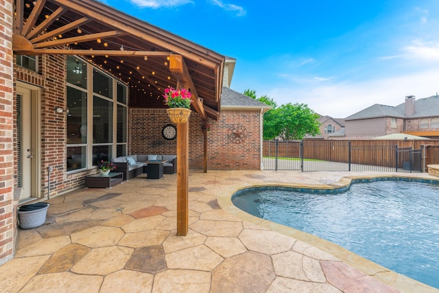 view of swimming pool featuring fence, a fenced in pool, a patio area, and outdoor lounge area