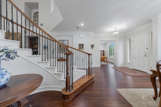 entrance foyer featuring crown molding, stairs, wood finished floors, and visible vents
