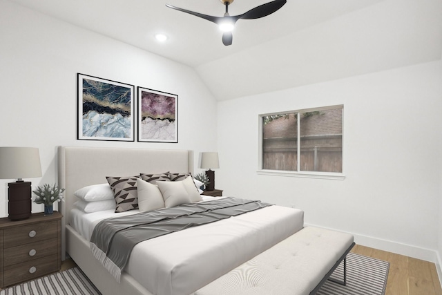 bedroom featuring a ceiling fan, baseboards, wood finished floors, and lofted ceiling