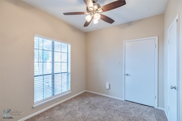 unfurnished bedroom with baseboards, carpet flooring, and a ceiling fan