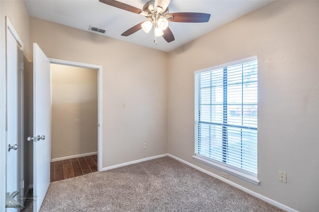 unfurnished bedroom with visible vents, a ceiling fan, carpet, and baseboards