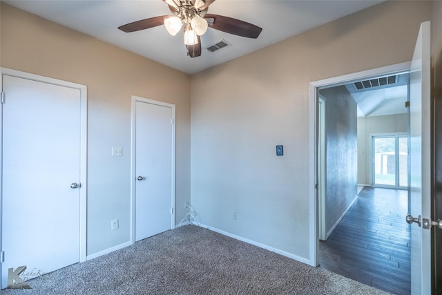 unfurnished bedroom featuring carpet flooring, baseboards, and visible vents