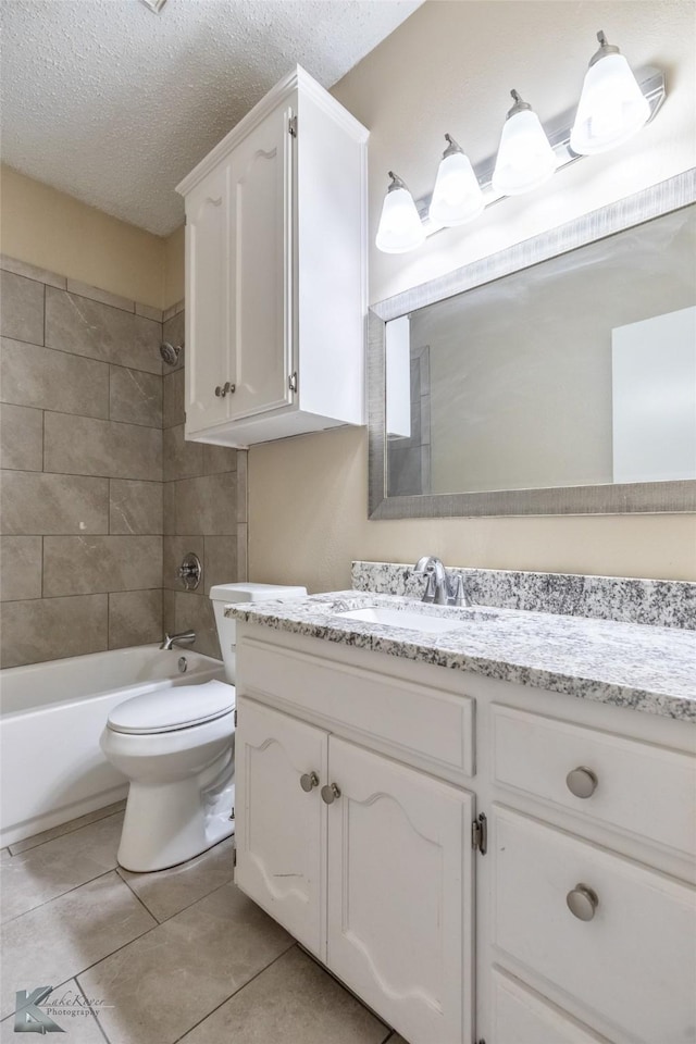 bathroom featuring vanity, toilet, a textured ceiling, tile patterned floors, and shower / bath combination